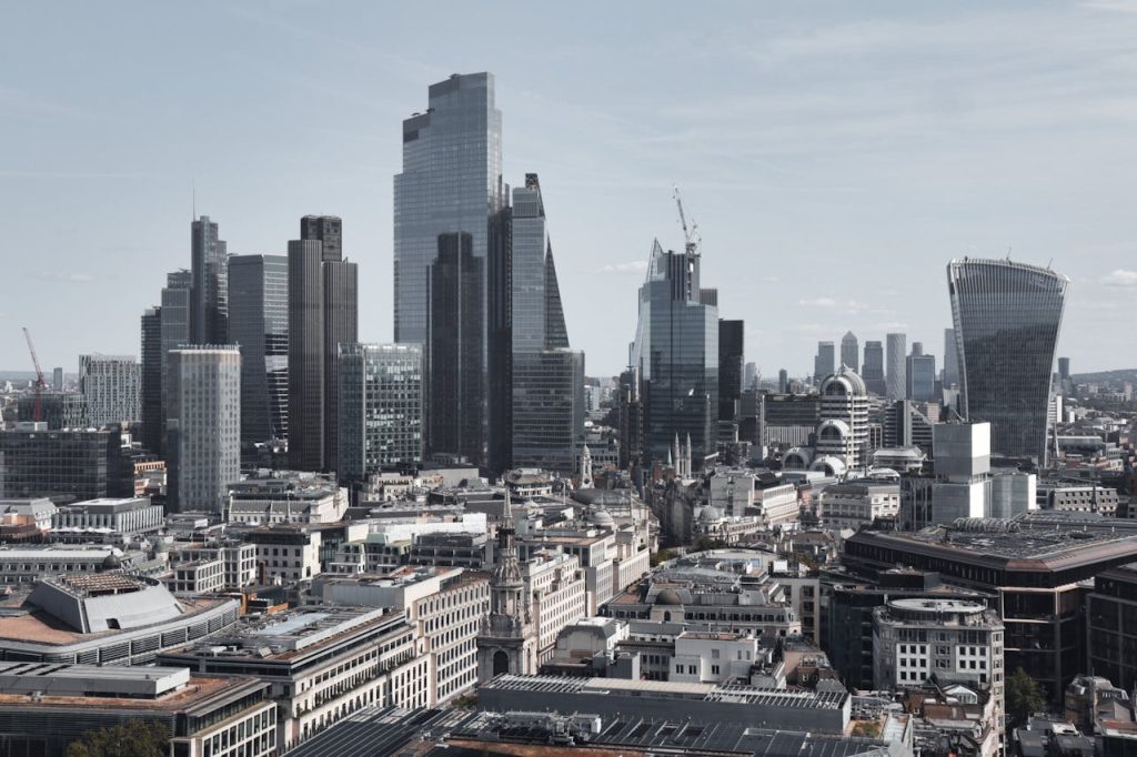 Stunning aerial view of London's financial district featuring modern skyscrapers under a clear sky.